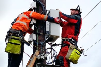 Two technicians working up an electrical pylon